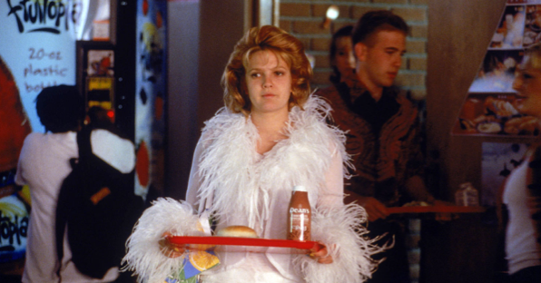 Still from cafeteria scene in film NEVER BEEN KISSED, of protagonist Julia dressed in outrageous clothes, wondering with whom she should sit at lunch.